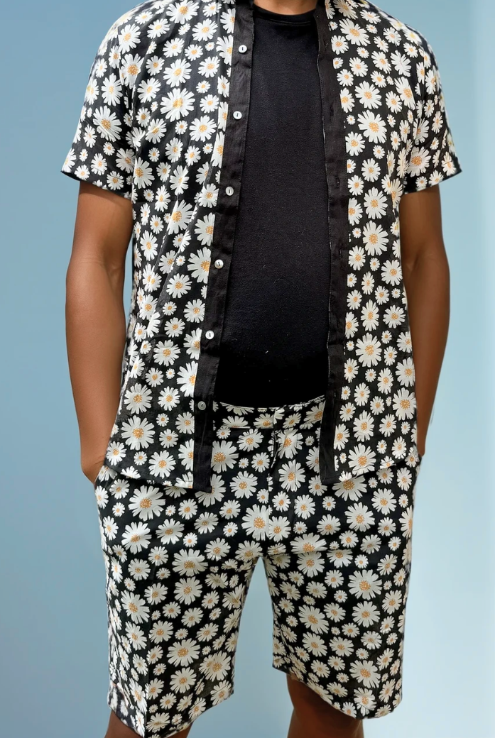 Sea Dragon Studio Daisy Cutter Shorts with black base and white daisy print, featuring a relaxed mid-thigh summer fit.