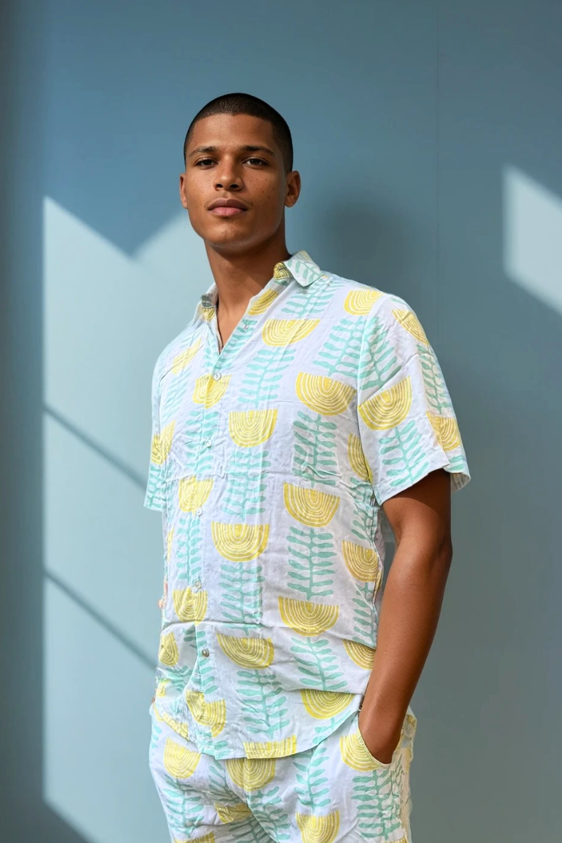 Model wearing the Green & Gold Summer Sessions Shirt in lightweight rayon, featuring green and gold print and relaxed short-sleeve fit.
