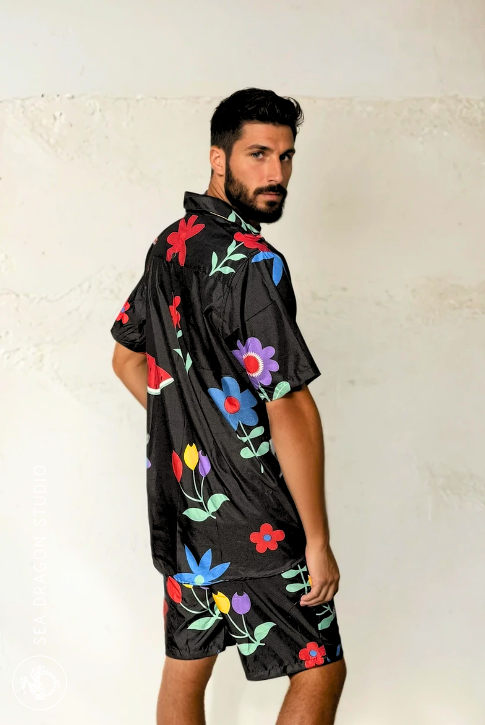 Back view of Midnight Picnic shirt pattern featuring bright flowers and fruit on black background.