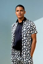 Model wearing the Sea Dragon Studio Daisy Cutter summer set in cotton with daisy print, styled for warm weather days.