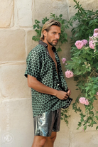 Side view of the Green and Pleasant Land shirt worn open, highlighting the relaxed fit and green summer print.