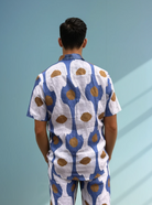 Back view of the Into the Sun men’s linen shirt and shorts set in blue dot print.