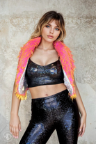 Model wearing Sea Dragon Studio’s Heatstroke reversible fur vest in neon pink and orange shaggy faux fur.