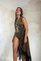 Model wearing Sea Dragon Studio’s gold sequin kimono vest with hood and long black fringe, styled over a festival bodysuit.